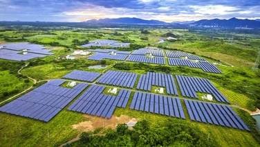 areal view of a solar farm in a green field