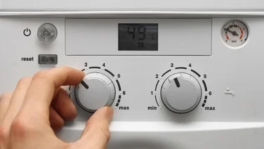 a person changes the settings on a vaillant boiler