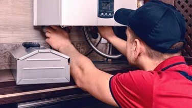 a man installs a combi boiler