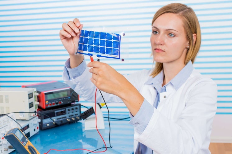 woman holding thin film solar panel