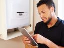 a technician assesses how much a new boiler will cost the owner