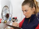 female boiler technician works on a boiler