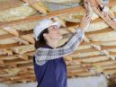 woman installs loft insulation