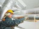 woman fitting pipe insulation