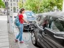 woman charging electric vehicle