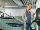 woman charges her electric vehicle
