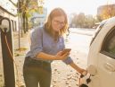 woman charging electric vehicle