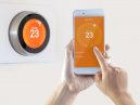 person controlling a smart thermostat
