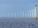 a row of wind turbines in sea