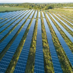 Solar panel farm with long rows of solar panels in a Cornish field