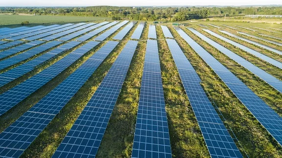Solar panel farm with long rows of solar panels in a Cornish field