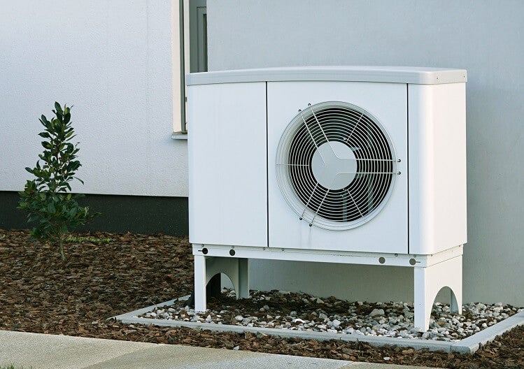 Air source heat pump outside a modern property