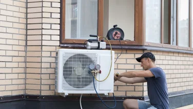 person installing a heat pump