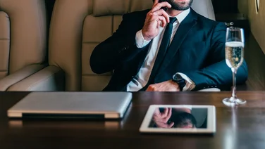 Businessman on a private jet taking a phone call