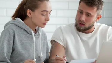 man and woman looking at their energy bills