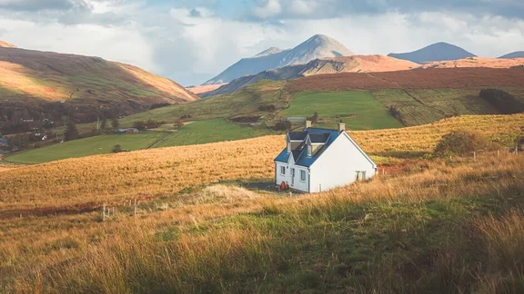 Property in the middle of the Scottish wilderness with hills in the background