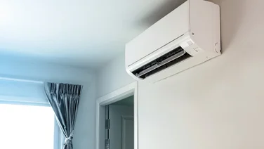 air conditioning unit attached to wall in house