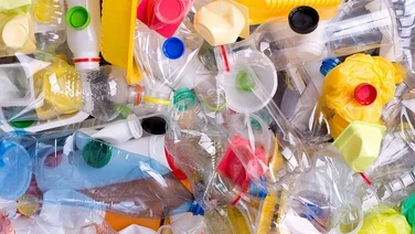 Plastic bottles and containers in a pile for recycling