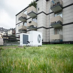 ground source heat pumps installed on lawn outside a block of flats