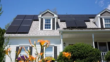 house with solar panels under a blue sky