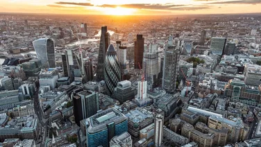 areal view of London cityscape, sun setting in background
