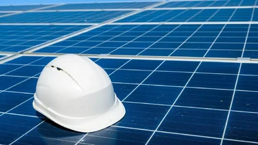 A hard hat on a solar panel