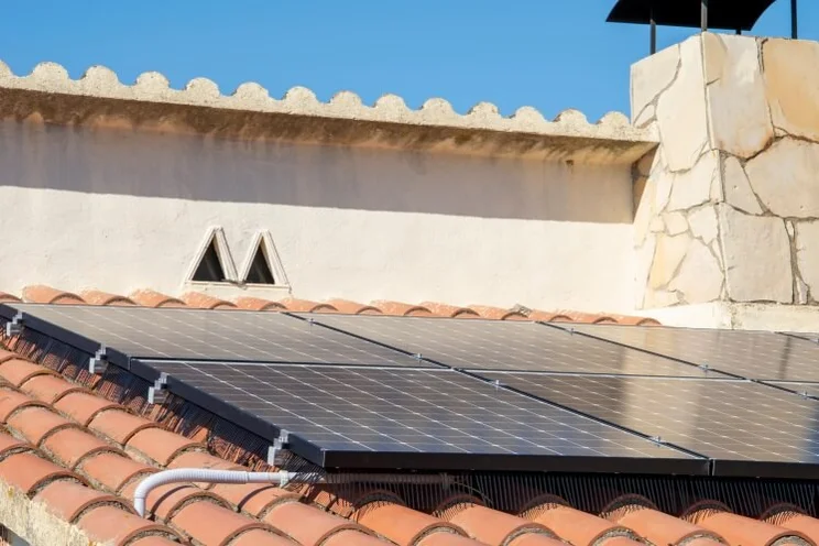 solar panels on a roof with terracotta tiles