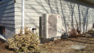 Air source heat pump outside a home.