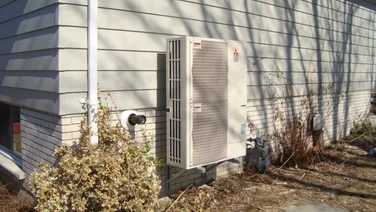 Air source heat pump outside a home.